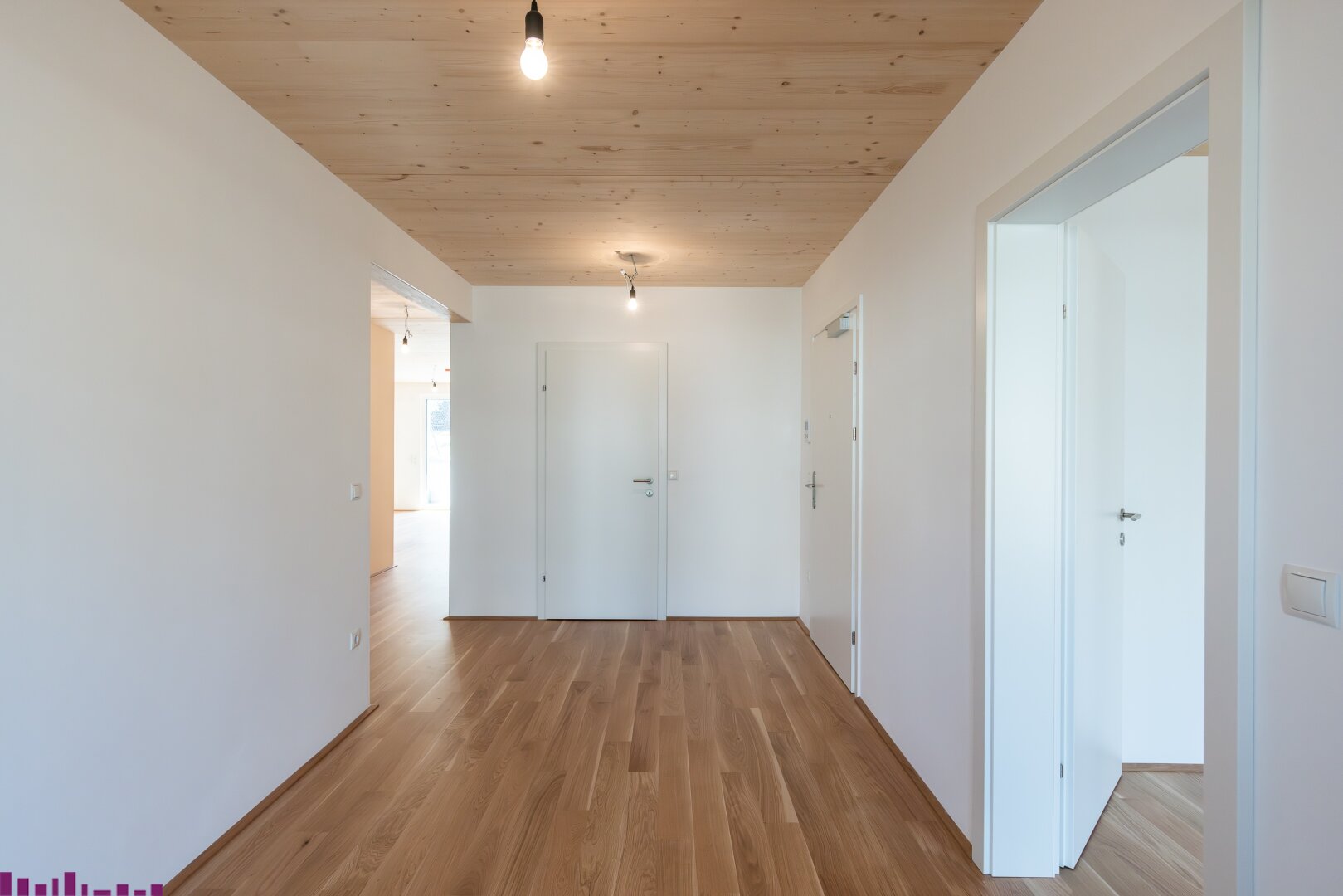 Zimmer mit Sichtholzdecke und Holzboden